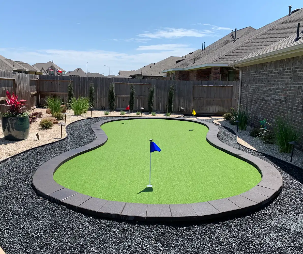 Kidney-shaped backyard putting green with flags in a Houston yard