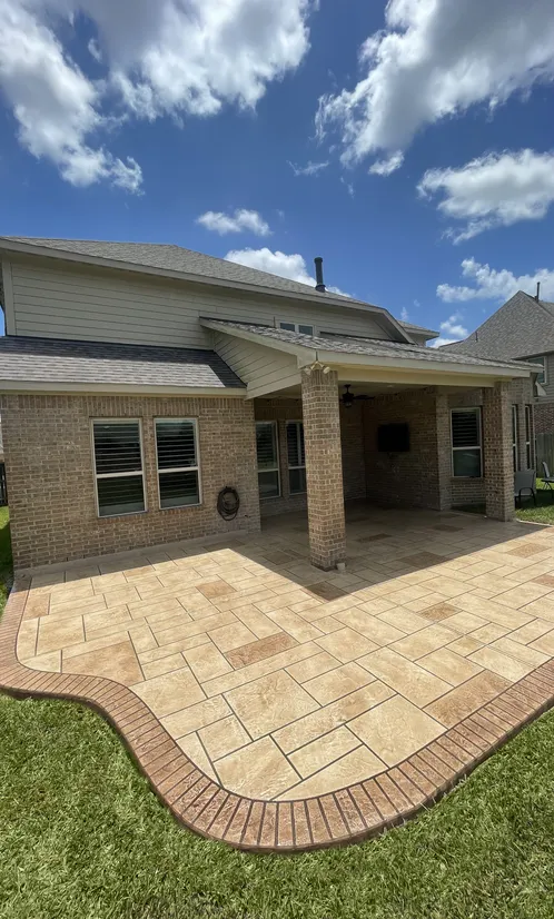 Stamped concrete patio with ashlar pattern and contrasting border in a Houston backyard
