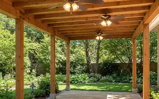 Open cedar pergola with three ceiling fans above a stone garden path