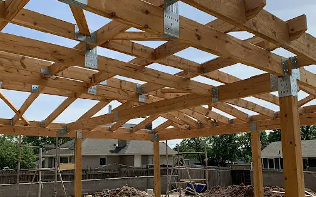 Cedar pergola framing with galvanized metal brackets during construction